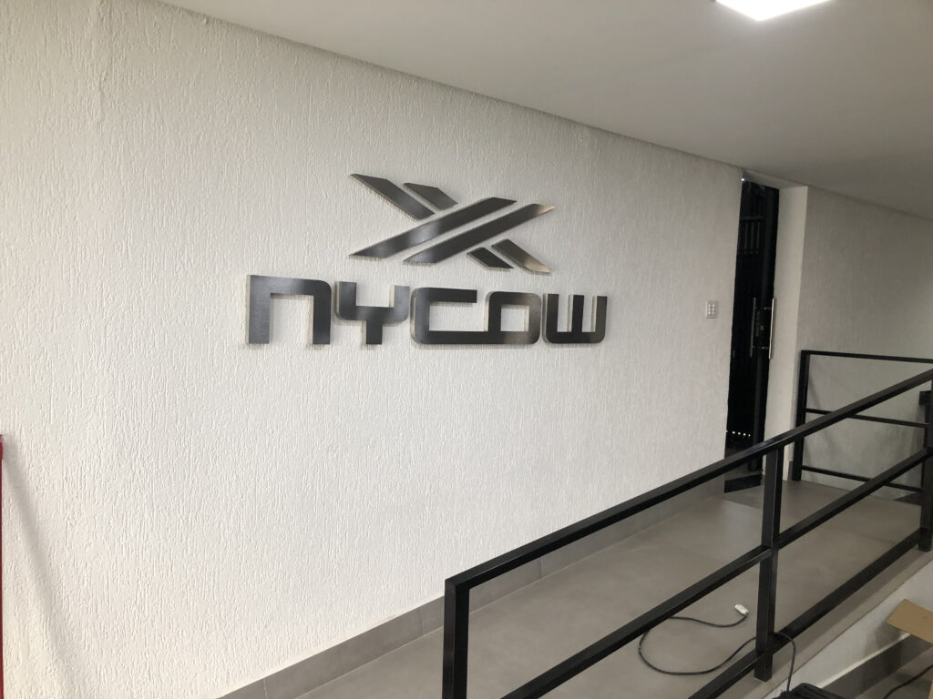 Letra-bloco em aço escovado.