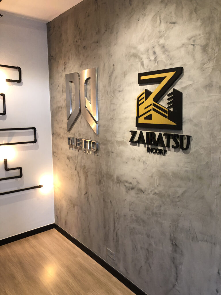 Letra-caixa em aço escovado.